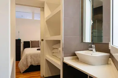 a bathroom with a sink and a bedroom with a bed at Nice apartment in Gracia - Torrent de l'Olla in Barcelona