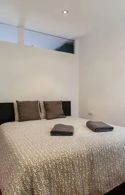 a bedroom with a bed with two pillows on it at Nice apartment in Gracia - Torrent de l'Olla in Barcelona