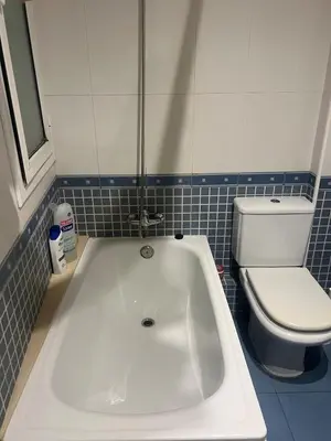 a white bath tub in a bathroom with a toilet at Flat in centre of Barcelona in Barcelona