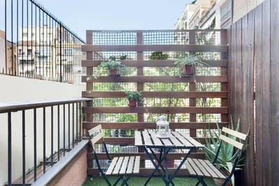 a patio with a table and chairs on a balcony at Suites4days Ali bei Apartment in Barcelona