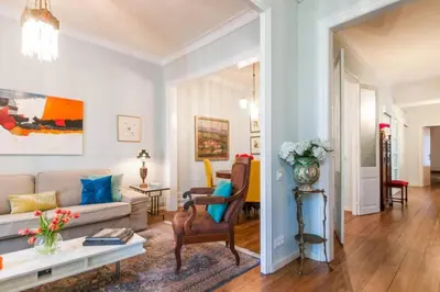a living room with a couch and a table at Explore City Center from an Elegant Urban Retreat in Barcelona