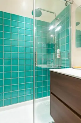 a bathroom with blue tiled walls and a shower at Explore City Center from an Elegant Urban Retreat in Barcelona