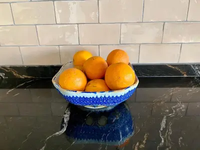 a blue bowl of oranges sitting on a counter at Fabulous Luxury in Best Location of City Centre in Barcelona