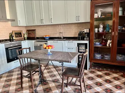 a kitchen with a table with a bowl of fruit on it at Fabulous Luxury in Best Location of City Centre in Barcelona