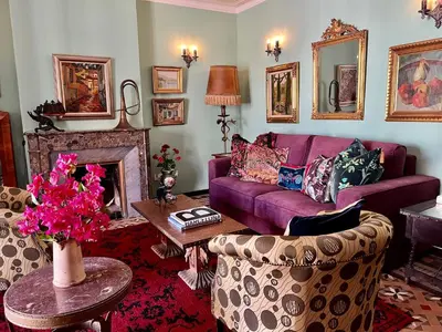 a living room with a purple couch and a fireplace at Fabulous Luxury in Best Location of City Centre in Barcelona