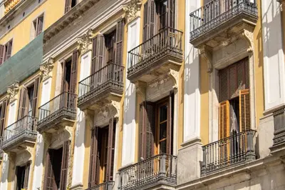 a facade of a building with windows and balconies at Hostal Ambos Mundos in Barcelona
