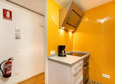 a kitchen with an orange and white wall at Tapioles · Lovely apartment in Poble Sec in Barcelona