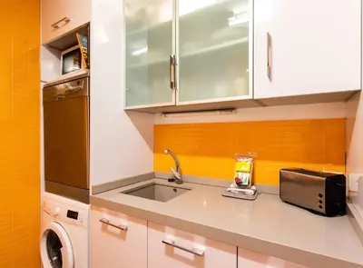 a kitchen with a sink and a microwave at Tapioles · Lovely apartment in Poble Sec in Barcelona