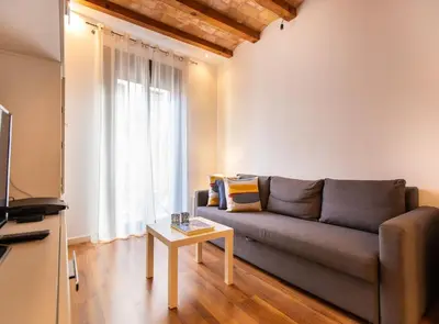 a living room with a couch and a coffee table at Tapioles · Lovely apartment in Poble Sec in Barcelona