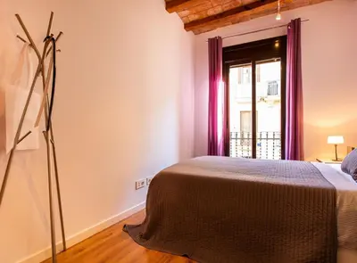 a bedroom with a bed and a window at Tapioles · Lovely apartment in Poble Sec in Barcelona
