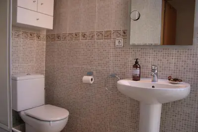 a bathroom with a toilet and a sink at Urgell - Lovely apartment with a terrace in Barcelona
