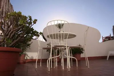 a white table and chairs on a patio at Urgell - Lovely apartment with a terrace in Barcelona