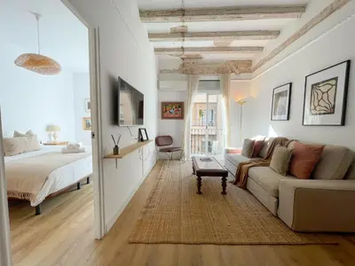 a living room with a couch and a bed at Boutique Radas in Barcelona
