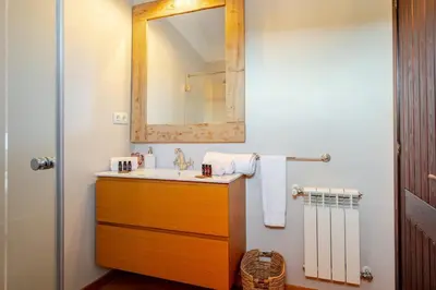 a bathroom with a sink and a mirror at Masía La Torre Historia Encanto y Naturaleza a Solo 10 Minutos de Sitges Gran comodidad, Vista a los Viñedos en un pueblo autentico in Viladellops