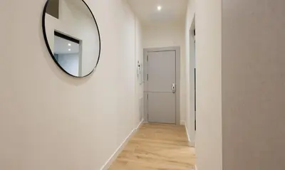 a hallway with a mirror on a wall at Stay U-nique Apartments Font BCN in Hospitalet de Llobregat