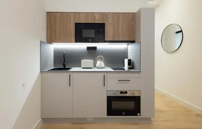 a kitchen with a sink and a microwave at Stay U-nique Apartments Font BCN in Hospitalet de Llobregat