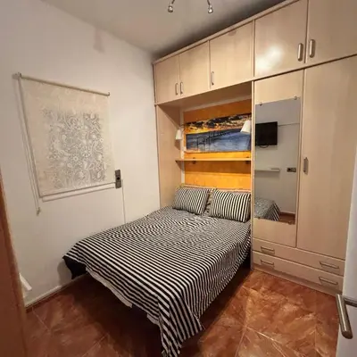 a small bedroom with a bed in a room at FlexCo City - Barcelona Flats in Barcelona
