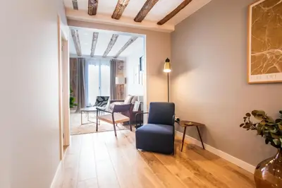 a living room with a blue chair and a table at E2MAL1052 - Fantastic apartment next to Sagrada Fa in Barcelona