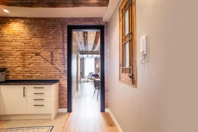 a kitchen with a brick wall and a hallway at E2MAL1052 - Fantastic apartment next to Sagrada Fa in Barcelona