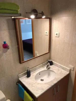 a bathroom with a sink and a mirror at Loft en Arenys de Mar in Arenys de Mar