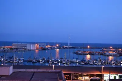 a marina with boats in the water at night at Loft en Arenys de Mar in Arenys de Mar