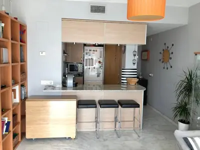 a kitchen with a counter with bar stools at Loft en Arenys de Mar in Arenys de Mar