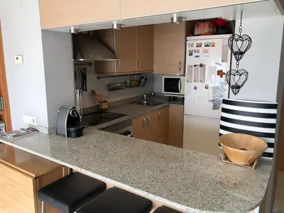 a kitchen with a counter top and a refrigerator at Loft en Arenys de Mar in Arenys de Mar