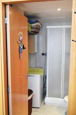 a bathroom with a shower and a toilet and a door at Loft en Arenys de Mar in Arenys de Mar