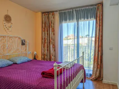 a bedroom with a bed and a large window at Modern Apartment near the sea in Pineda de Mar