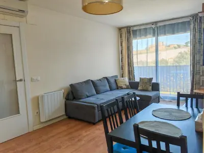 a living room with a couch and a table at Modern Apartment near the sea in Pineda de Mar
