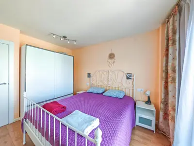 a bedroom with a purple bed in a room at Modern Apartment near the sea in Pineda de Mar