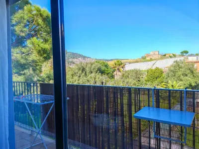 a balcony with a blue table and a view at Modern Apartment near the sea in Pineda de Mar