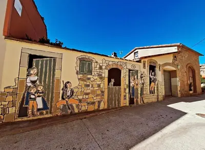 a mural on the side of a building at Cal Rami in Castellbell i Vilar
