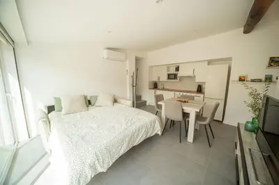 a bedroom with a bed and a table and a kitchen at Cal Rami in Castellbell i Vilar