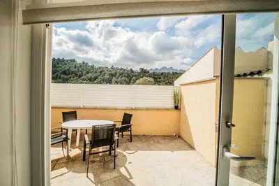 a view of a patio with a table and chairs at Cal Rami in Castellbell i Vilar
