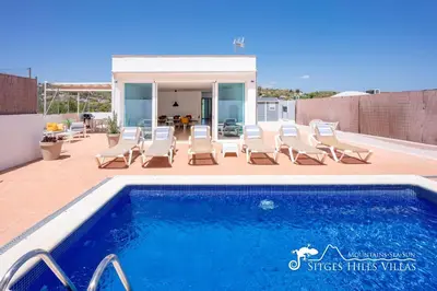 a swimming pool with lounge chairs and a house at Villa Senita with Private Pool, close to Sitges in Olivella
