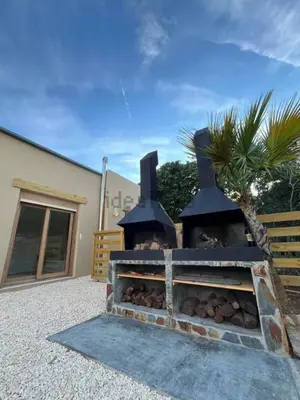a brick oven with logs inside of it at Stylish & idyllic Finca with private garden 5 min walking from South Beach Barcelona in Gava Mar in Barcelona