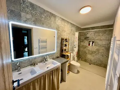 a bathroom with a sink and a mirror and a toilet at Stylish & idyllic Finca with private garden 5 min walking from South Beach Barcelona in Gava Mar in Barcelona