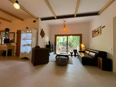 a living room with a couch and a table at Stylish & idyllic Finca with private garden 5 min walking from South Beach Barcelona in Gava Mar in Barcelona