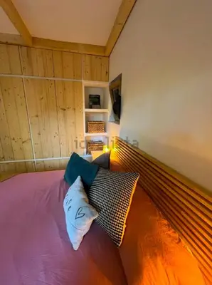 a bed with two pillows on it in a room at Stylish & idyllic Finca with private garden 5 min walking from South Beach Barcelona in Gava Mar in Barcelona