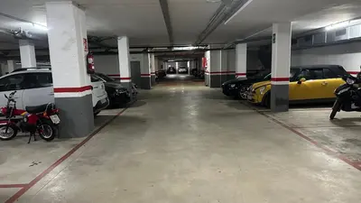 a parking garage with several cars parked in it at Apt compartido martirrena in Badalona
