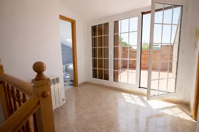 an empty room with a staircase and a large glass door at Nature & Tranquility only 25km from Barcelona in Torrelles de Llobregat