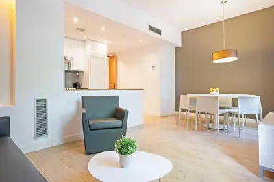 a living room with a chair and a table at Ola Living Viladomat in Barcelona