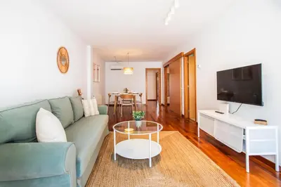 a living room with a couch and a tv at Mai&Maud Fira Apartment in Hospitalet de Llobregat