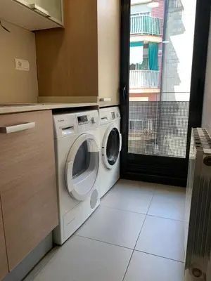 a washer and dryer in a kitchen with a window at Mai&Maud Fira Apartment in Hospitalet de Llobregat
