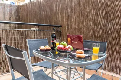 a glass table with fruit and a bottle of wine at CITY CENTER TWO BEDROOMS APARTMENT, IN A 1870's FULL RENEWED BUILDING in Barcelona