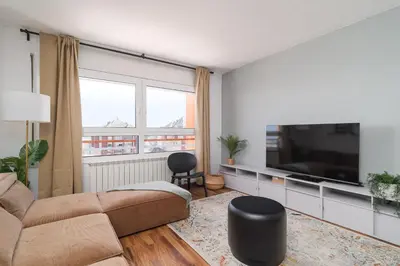 a living room with a couch and a flat screen tv at Bright Apt With Amazing Views in Barcelona