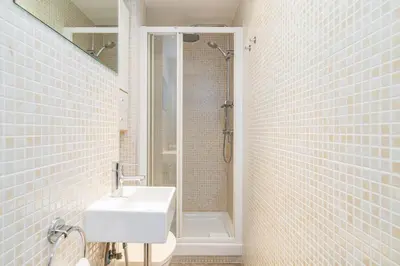 a white bathroom with a sink and a shower at Bright Apt With Amazing Views in Barcelona