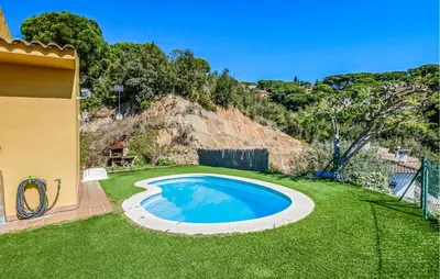 a swimming pool in a yard with green grass at Stunning Home In Arenys De Munt in Arenys de Munt