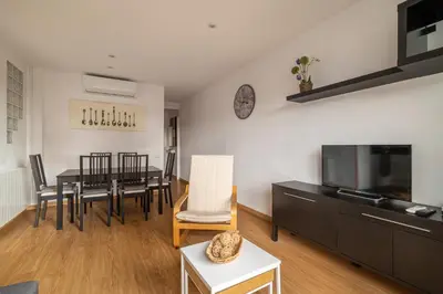 a living room with a dining table and a television at Stay U-nique Apartments Lepant II in Barcelona